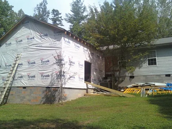 Tyvek wrapped gable on a new room addition beside an existing home in Westfield